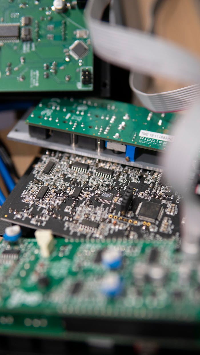 why-choose-us Vertical shot of stacked circuit boards showcasing intricate electronic design and components.