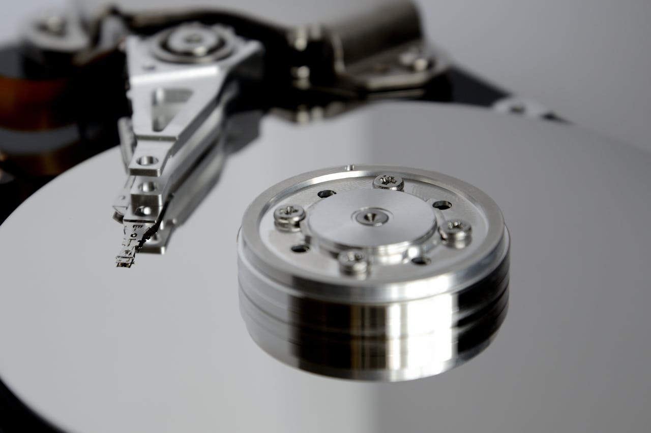 services-01 Detailed view of hard drive mechanism showcasing metallic precision parts.